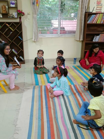 A storyteller begins a new tale, her expressive face immediately drawing the children in.