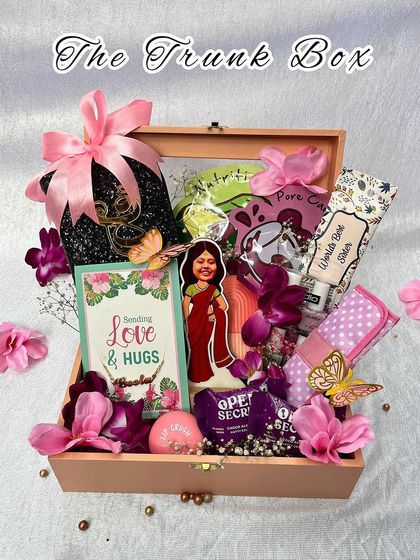 The "Trunk Box" is a beautiful keepsake gift for a sister. This wooden trunk is filled with personalized items, snacks, and a custom caricature, making it a truly special present.