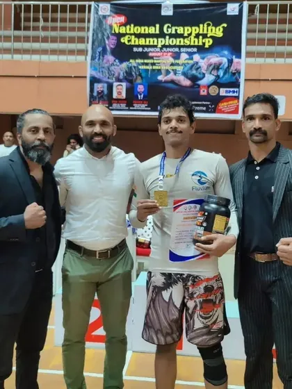 Receiving my gold medal and prizes at the National Grappling Championship in Kozhikode. It was a well-organized event and a great experience.