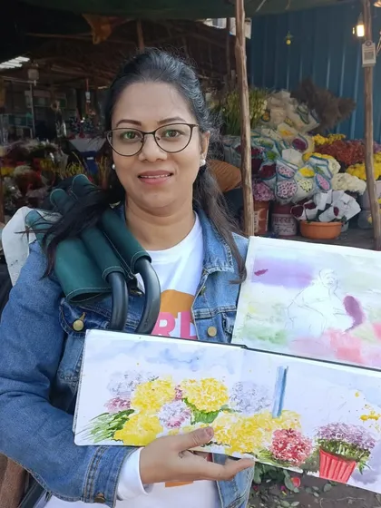 At the Mehrauli flower market in Delhi, holding up the watercolor paintings I created on the spot. The market is a riot of color and a fantastic place for live painting.