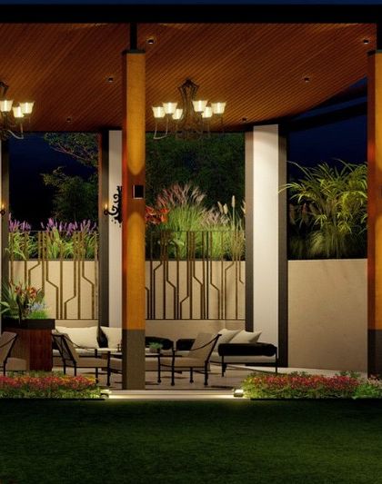 Another angle of the Meerut property's outdoor pavilion. The design uses a combination of wood, stone, and decorative metalwork, along with classic chandeliers, to achieve a look of opulent comfort.