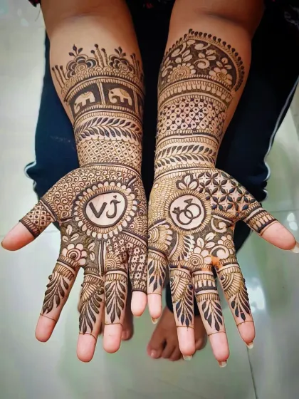 Your engagement mehandi can be a reflection of your love story. Here, I've incorporated the couple's initials "VJ" and engagement ring symbols into a traditional design filled with elephant motifs and detailed patterns.
