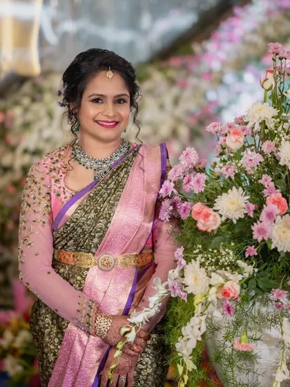 This client chose a beautiful contrast for her reception look. I designed a blouse with sheer pink sleeves and delicate gold embroidery to pair with her olive green and pink brocade saree.