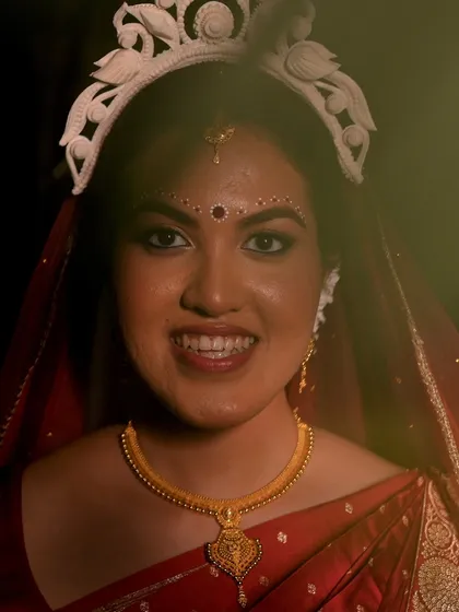 A close-up of my Bengali bride, Piyashi. The simple, elegant kolka design above her brows is a key element of the traditional look.