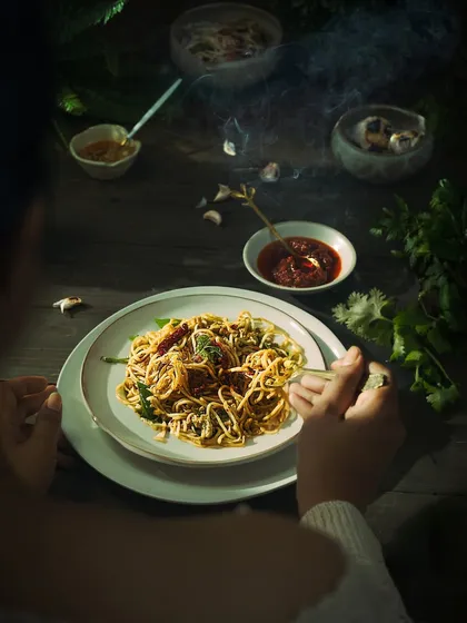 A great food video makes you feel hungry. We focus on capturing sensory details like the steam rising from these hot chilli garlic noodles, making the dish feel alive and irresistible.