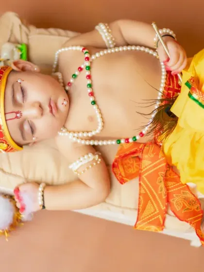 Even little gods must rest. A peaceful shot of a baby Krishna sleeping on a miniature cot, showing the quiet side of this theme.