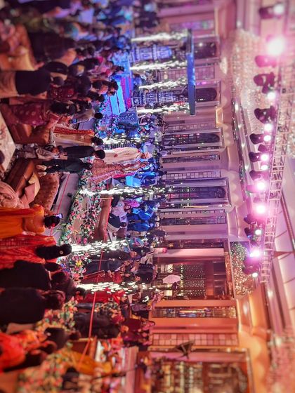 A top-down drone photograph of a packed audience during a live event. This perspective is perfect for showing the full house and the energy of the crowd.