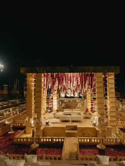 An amphitheater-style seating arrangement at Suryagarh, Jaisalmer, provided every guest with a perfect view of the stunning mandap. The design integrated the venue's heritage architecture with our bespoke decor.