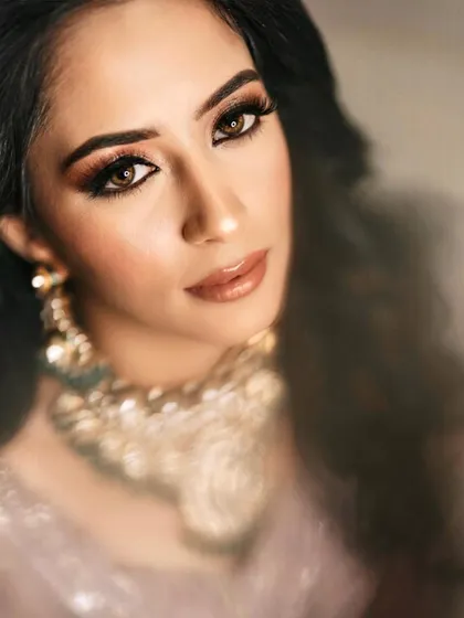 A dreamy, artistic shot of this reception bride. The close-up highlights the intricate details of her eye makeup and the beautiful glow of her skin.