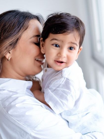 A mother whispering a secret to her little one. These are the sweet, candid moments I love to capture.