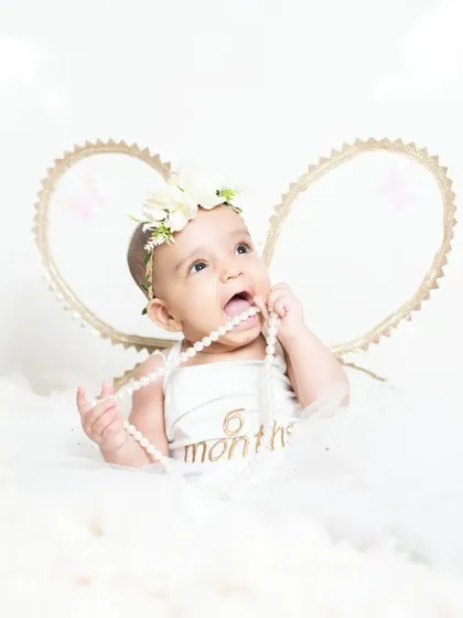 A six-month milestone photo with my angel theme. The "6 months" sign adds a personalized touch to celebrate this special age.