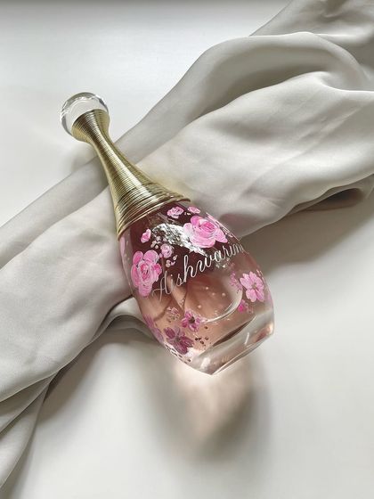 Taking inspiration from a reference photo to create a unique piece of art. This Dior J'adore bottle is hand-painted with pink florals, a beautiful interpretation rather than a direct copy.