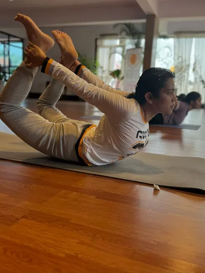 "You are only as young as your spine is flexible." A student demonstrates Dhanurasana (Bow Pose), an excellent backbend for strengthening the back muscles and improving posture.