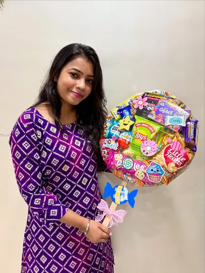 Here I am with a colorful lollipop hamper I made for Rakhi. Every single hamper is assembled by me, and it brings me so much joy to know they'll be part of your special moments.
