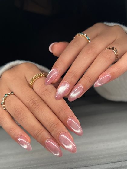 The full view of the chrome pink cat-eye nails. This manicure is perfect for someone who wants a touch of magic without being over the top.