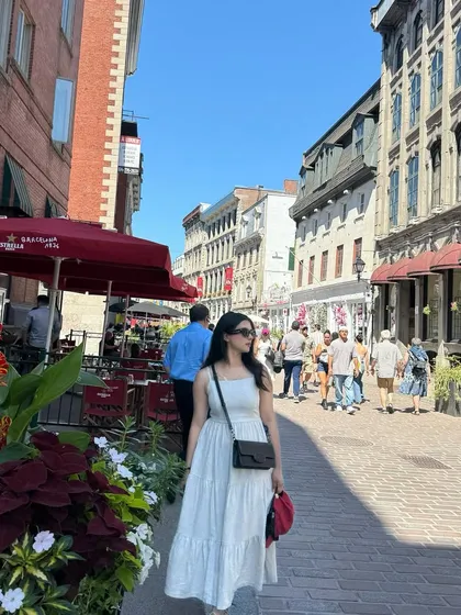 I create on-the-go content that feels authentic and captures a specific vibe. This shot from Old Port, Montréal, shows how I can model a brand's clothing in a real-world, bustling city environment, creating a candid and relatable travel story.