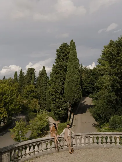 Overlooking the cypress trees of Tuscany from a historic villa. We seek out breathtaking views for our destination engagement shoots, creating frames that are as much about the landscape as they are about you.