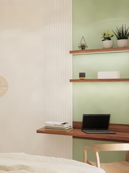 A compact study nook in the guest bedroom, featuring a floating desk and backlit shelves against a mint green wall.