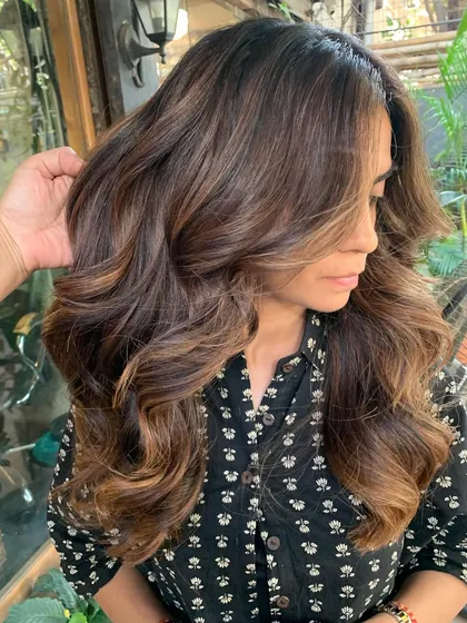 A side view of this warm, non-bleach brunette transformation. The layers and color work together to create a full, voluminous look.