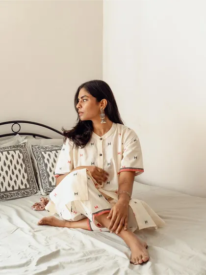A full-view lifestyle shot for an Indian wear brand, showing their kurta set in a natural, relaxed bedroom setting. My goal is to create visuals that feel authentic and help customers imagine the clothing in their own lives.
