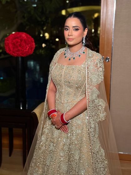 A full-length view of the bride's stunning reception outfit. The makeup is designed to be both glamorous and timeless, ensuring she looks perfect in her photos for years to come.