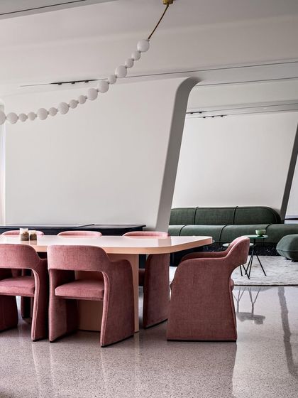This dining area in our Dona Paula project features a custom-designed table and chairs, with panoramic views of the sea. The design is minimal, allowing the stunning natural surroundings to be the focal point.