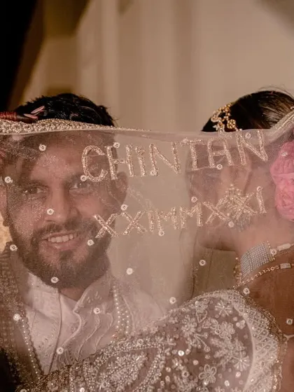 A personalized wedding veil with the groom's name embroidered on it. This is a unique detail we helped the bride plan to surprise her groom.