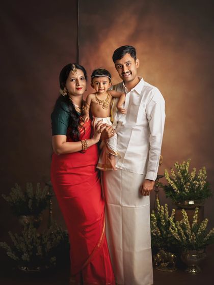 A beautiful family portrait celebrating their little Krishna. The traditional outfits and loving poses make this a truly special image.