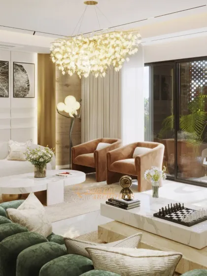 The interplay of light and color is central to this design. The warm tones of the armchairs contrast beautifully with the cool marble and lush greenery, creating a balanced and inviting atmosphere.