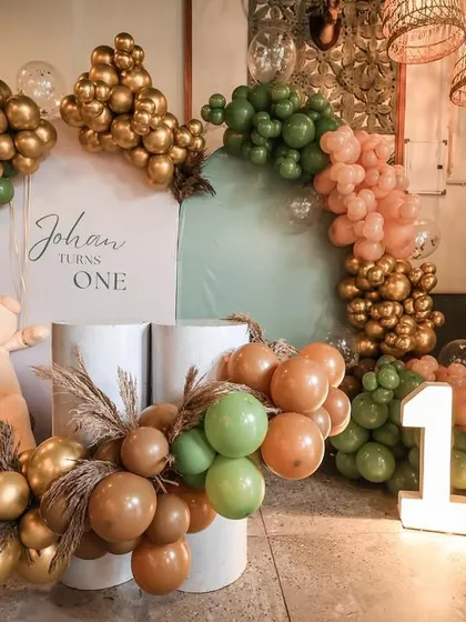 A rustic and chic teddy bear theme for Johan's first birthday, set in a cafe. We used a color palette of sage green, brown, and gold to complement the venue's decor.