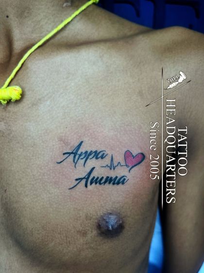 A chest tattoo with "Appa Amma" connected by a heartbeat line and a red heart, a tribute to parents.