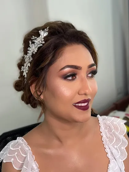 For this gorgeous Christian bride, we chose a sophisticated and glamorous look. I created a sparkling smokey eye and paired it with a bold wine-hued lipstick, complemented by an elegant bridal updo.