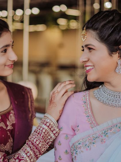 A sweet, candid moment between the bride and her sister. Capturing these precious family bonds is an essential part of telling the complete story of your day.