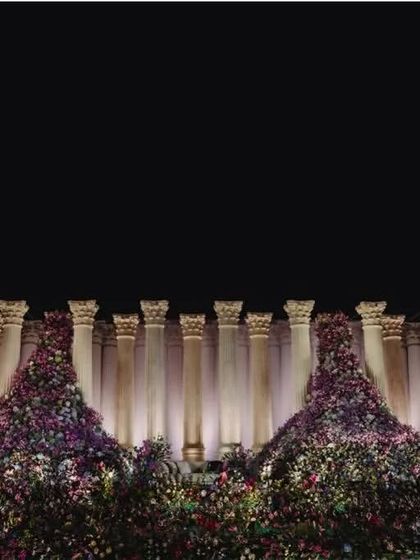 Another perspective of the Roman pillar stage, emphasizing the sheer height and organized pattern of the columns which provide a clean, powerful backdrop.