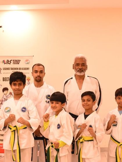 A group of newly promoted students with their examiner, Sabum Rakesh Kumar Verma, and their coaches.