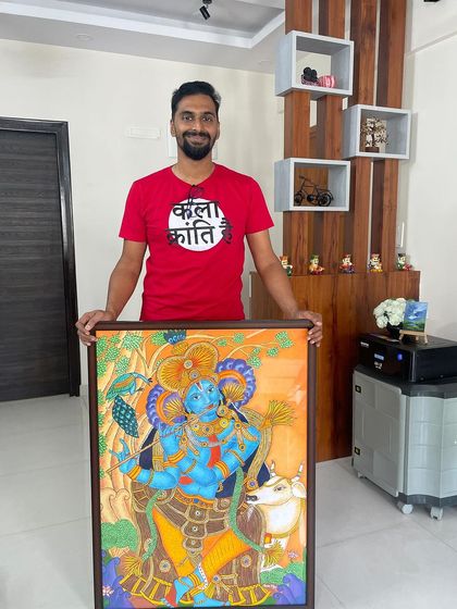 Posing with the finished Krishna mural. This was a challenging project that pushed my boundaries as an artist, and I'm incredibly proud of the result.