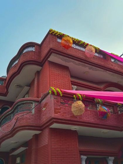 Another view of the red brick house, showing how the pink drapes create a beautiful contrast during the day.