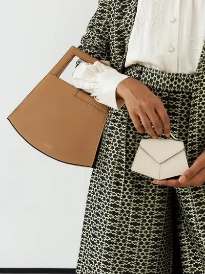 Styling for handbag brand Adisee, this shot shows how a large and a micro bag can be styled together. The focus is on the product, held against a patterned outfit.