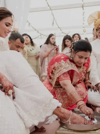 A touching moment as the bride's mother performs a traditional ritual, her love and blessings evident in her actions.