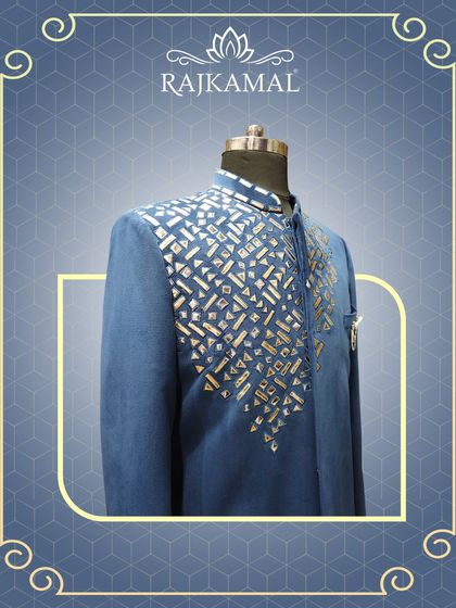 A blue Indo-Western jacket with striking geometric mirror work on the chest, perfect for adding a touch of sparkle to your wedding season wardrobe.