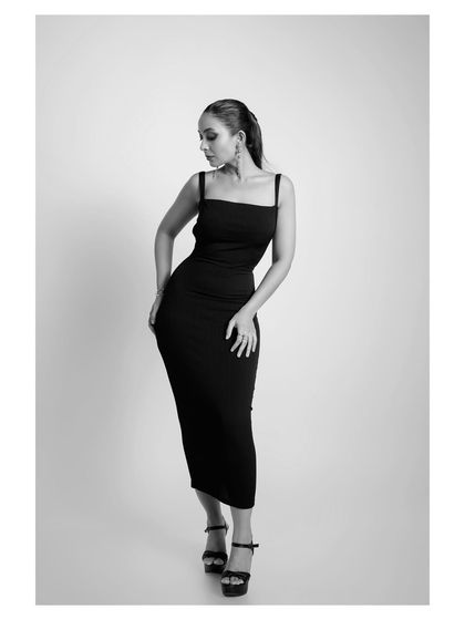 Another angle in black and white, this pose highlights the contours of the dress and the model's form.