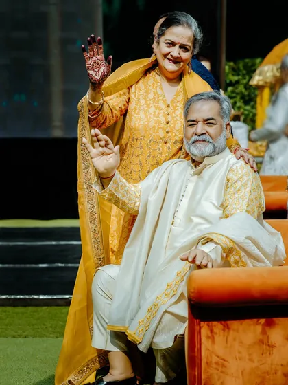 The joy of the elders is a beautiful part of any family gathering. Here, the bride's grandparents wave to guests during a vibrant Haldi ceremony, and we were there to capture their happiness.
