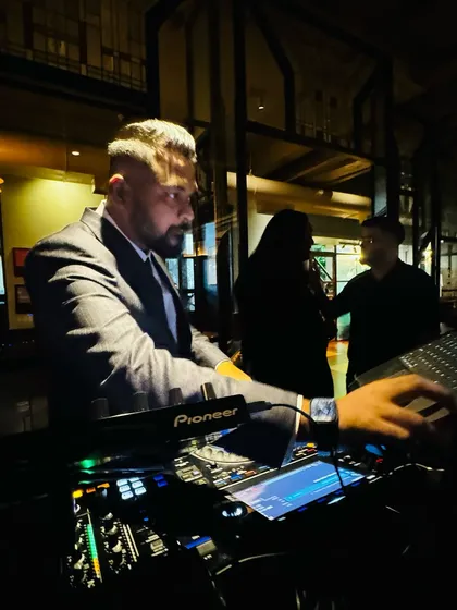 Adjusting the levels during a private event. The key is to keep the music present but not overpowering, perfectly complementing the event's mood.