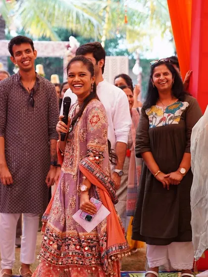 A candid shot of the emcee interacting with guests at a vibrant Punjabi Mehendi, showcasing the fun and games we help organize.