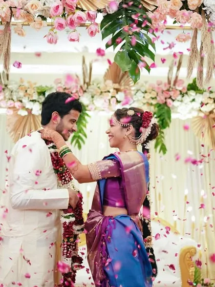 The joy of a wedding is infectious, and our goal is to capture that energy. This shot of a Varmala ceremony, with petals showering the happy couple, freezes a moment of pure celebration and laughter, reflecting the vibrant spirit of an Indian wedding.