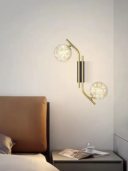 A beautiful wall sconce with two starry, textured globes. This fixture adds a touch of magic and elegance to this bedside.