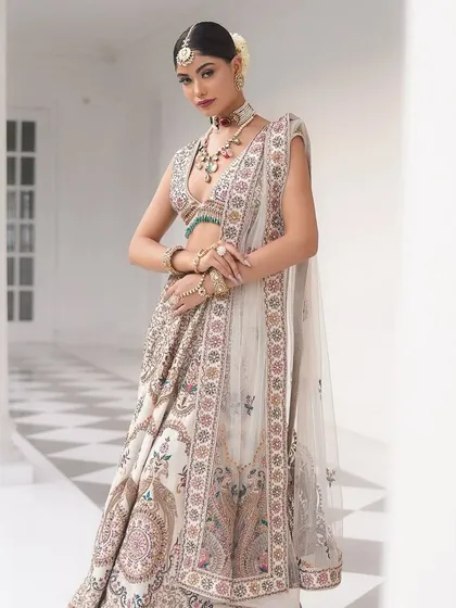 A full-length portrait showcasing the beautiful drape of the "Laila" lehenga. The styling is elegant and timeless.