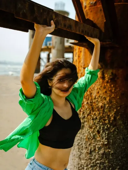 A dynamic shot with movement, as the wind catches her hair and shirt. This adds energy and a candid feel to the portrait.