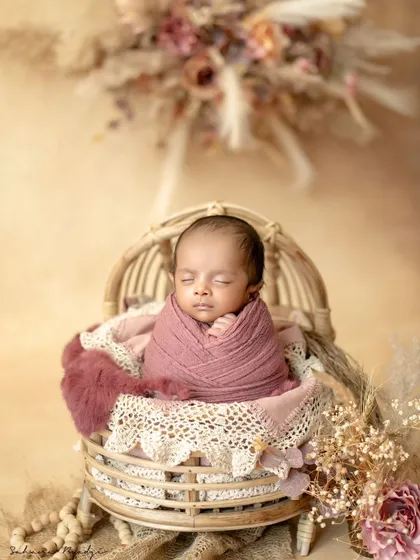 A pop of color for this sleeping beauty. The rich pink wrap and rustic basket create a beautiful contrast in this classic newborn portrait.