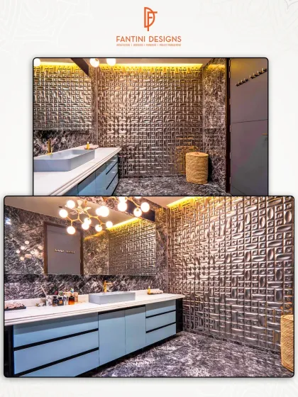 A bathroom that makes a statement with textured metal wall tiles, a sleek blue vanity, and dramatic lighting.